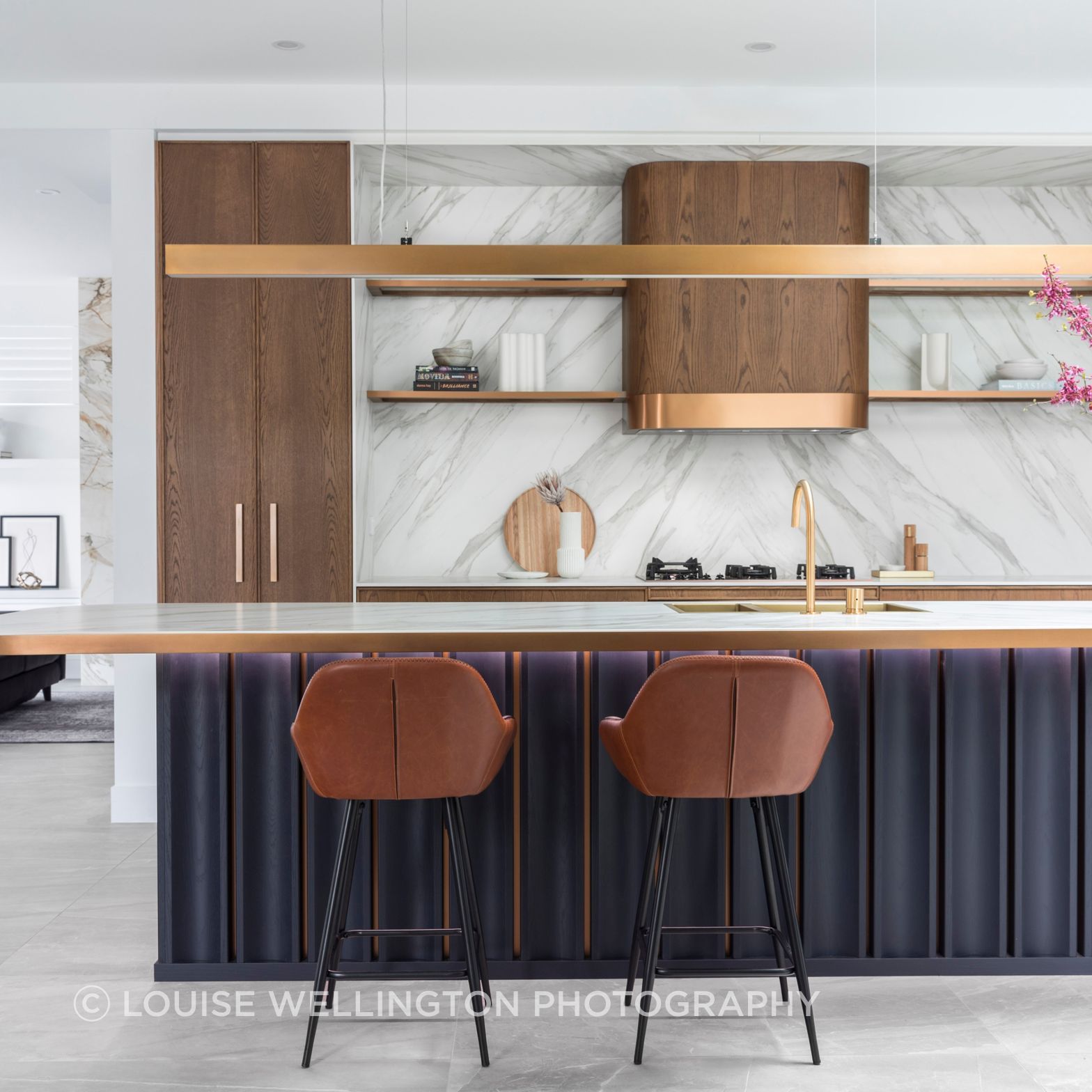 Oxford Project.   Luxury kitchen design, award winning home.  Features Neolith stone, Farmers Doors teak timber, curved rangehood and deep blue veneer.