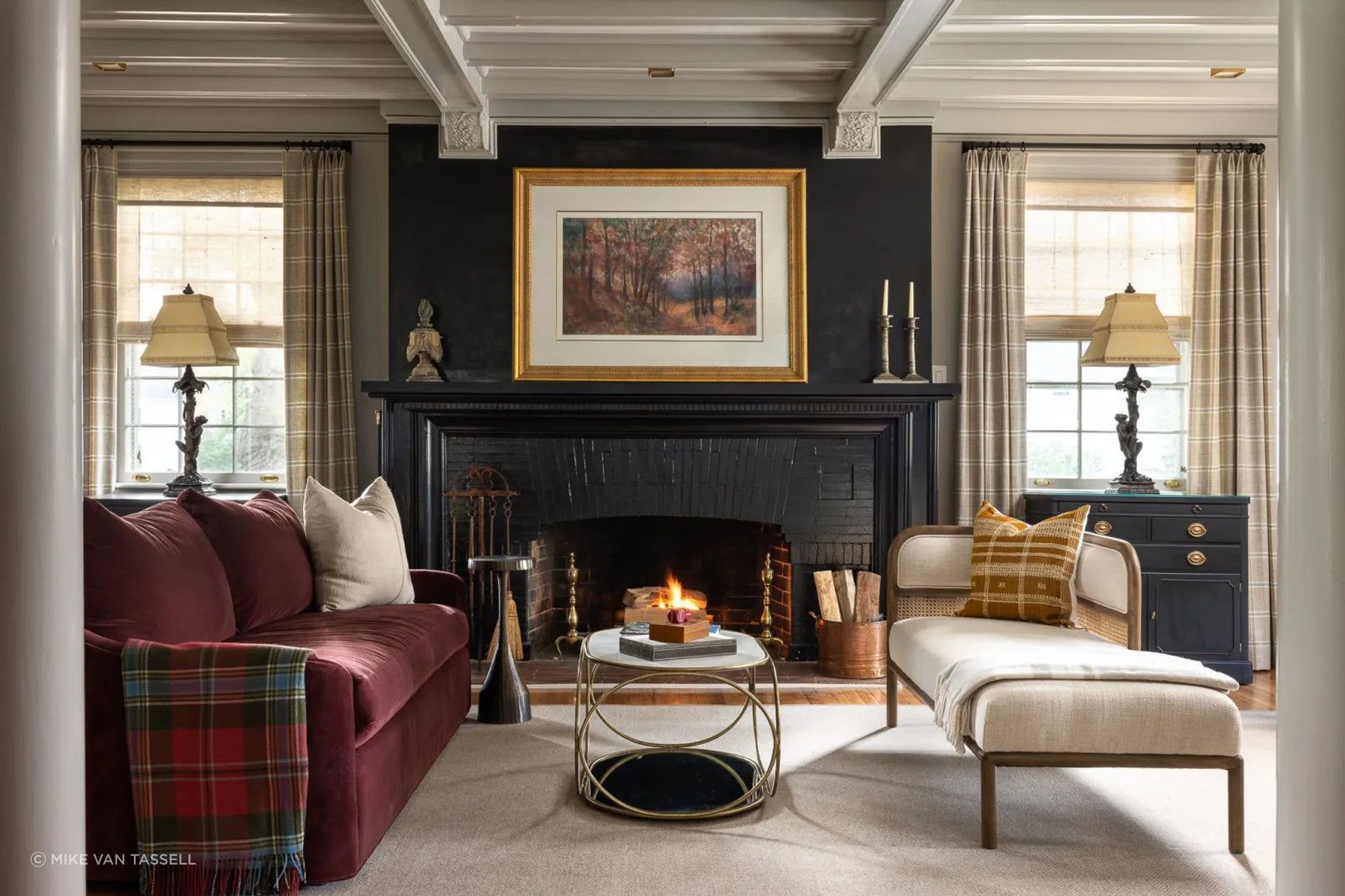 Submersing the fireplace in black anchors the space, while soft neutrals and pops of color add to the room’s personality.