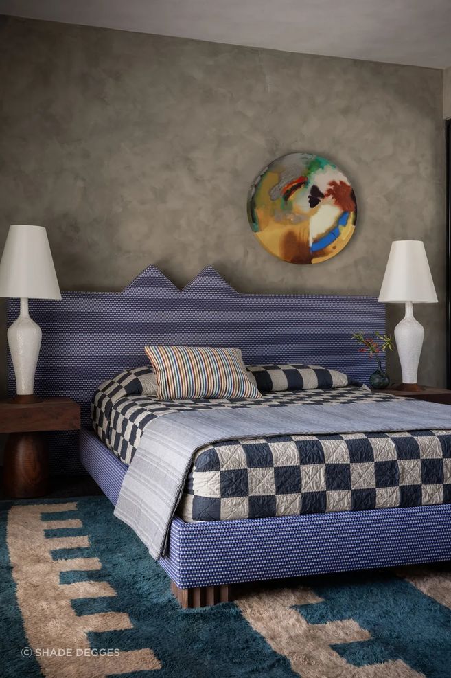 A Pamela Jorden painting hangs above a guest room’s custom bed, which is upholstered in Maharam fabric. Art: Pamela Jordan