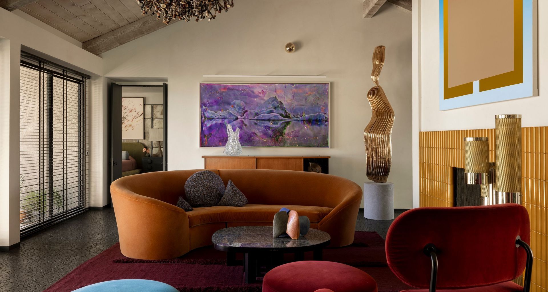 In the living area, a vintage sofa is grouped with a Ligne Roset armchair and Ado Chale coffee table; photograph by Matthew Brandt and painting by Michael Boyd ART: Matthew Brandt. Ritsue Mishima. Alma Allen. Michel and Andrée Hirlet. Clare Graham.