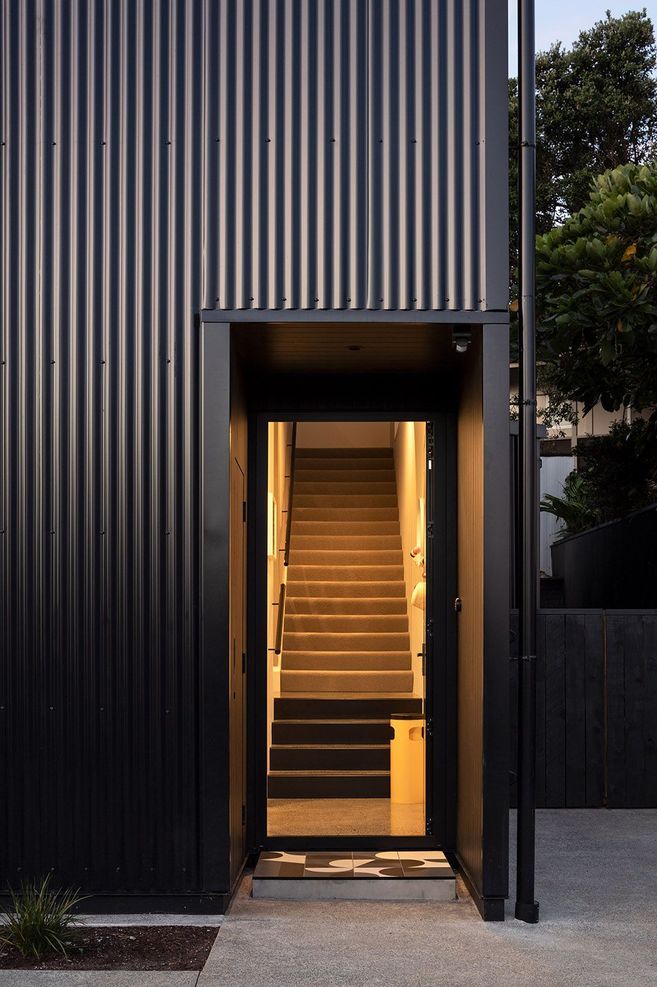 The front entrance features a geometric tiled entry mat.