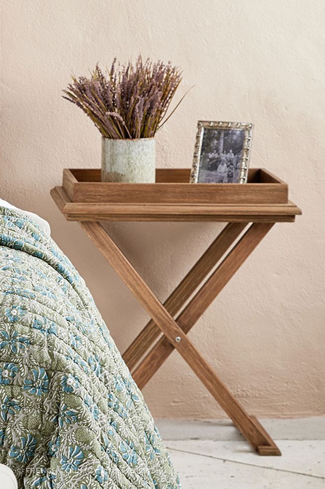 Exuding rustic charm and earthy tones, the cross leg tray table stands as a unique blend of functionality and style.