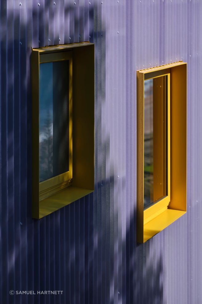 Windows in the building were very carefully considered to capture glimpses of the view. The powdercoated yellow joinery adds to the unconventional aesthetic.