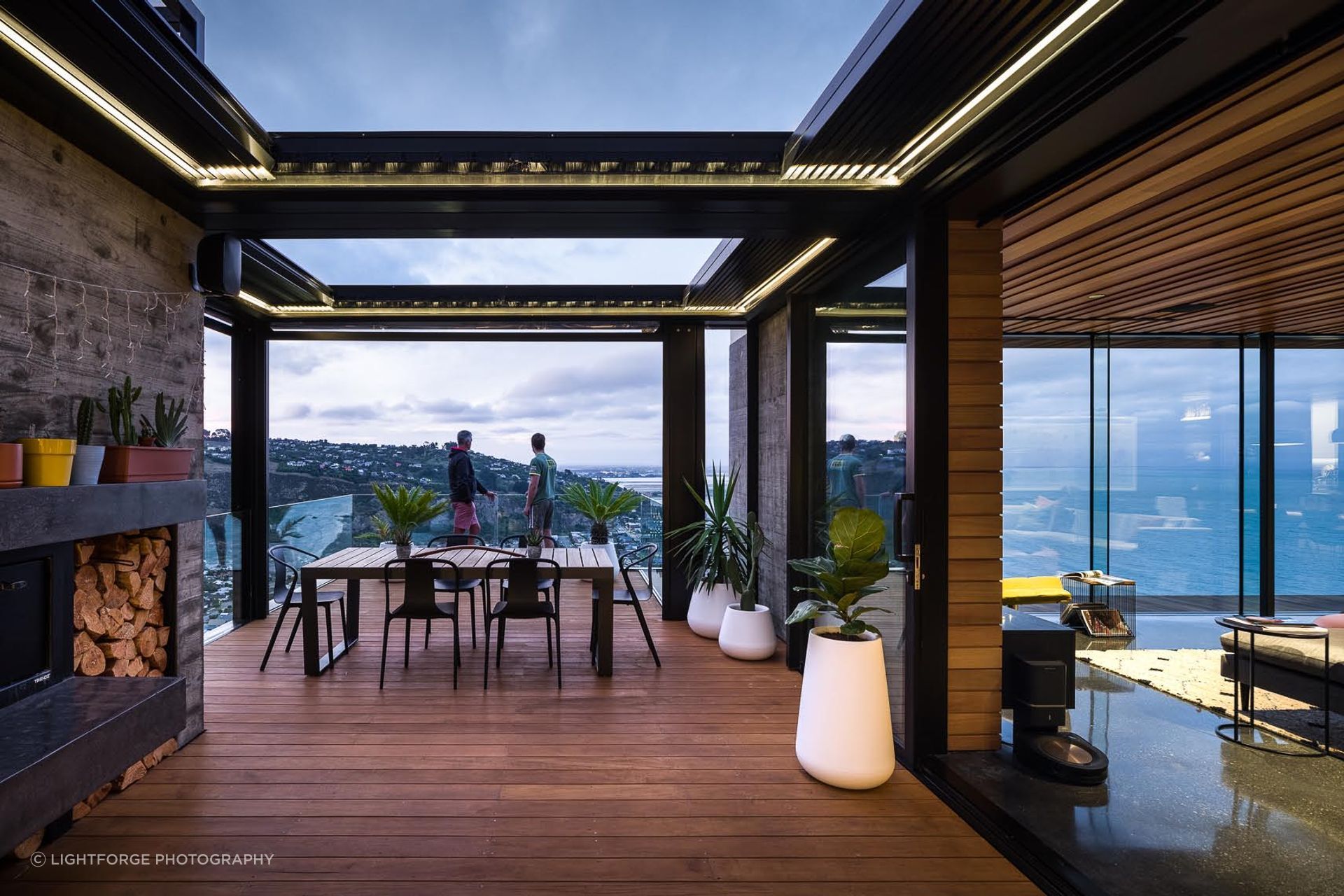 A protected outdoor area with louvred roof at the end of the living space provides a sheltered loggia and balcony from the elements.