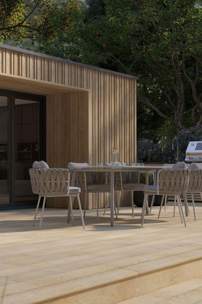 Envello board &amp; batten cladding in golden oak by Millboard Decking