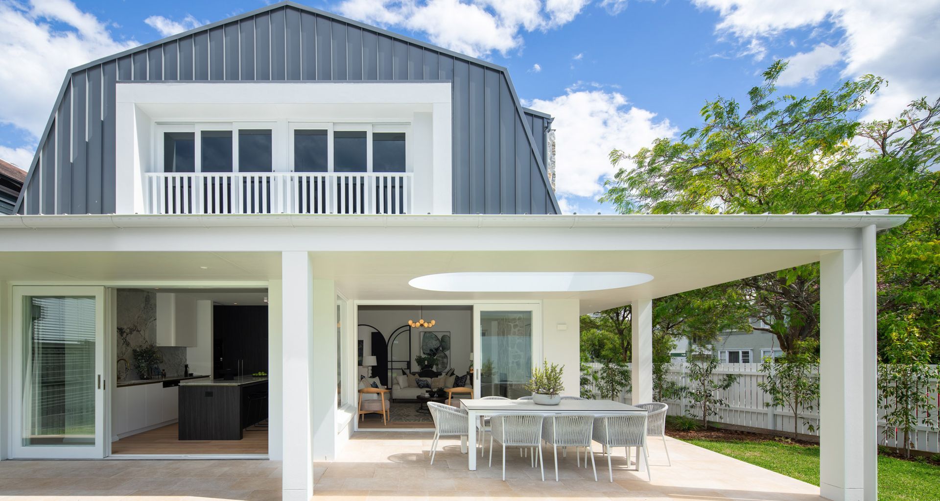 Lavarosa Limestone pavers bring warmth to the alfresco terrace at Barn House Randwick, bridging indoor and outdoor living with natural ease.