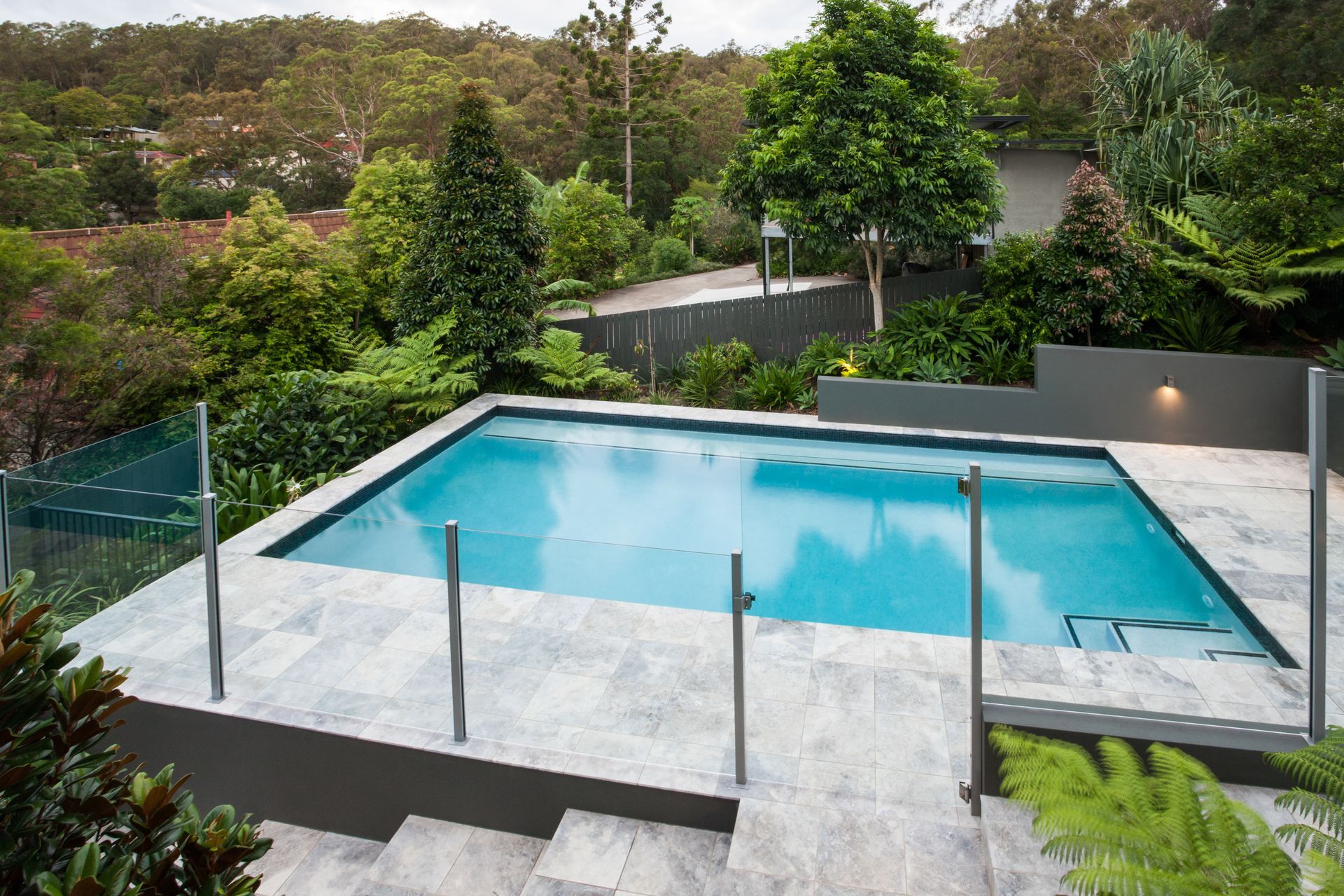 A semi-framed glass pool fence provides stability and safety.