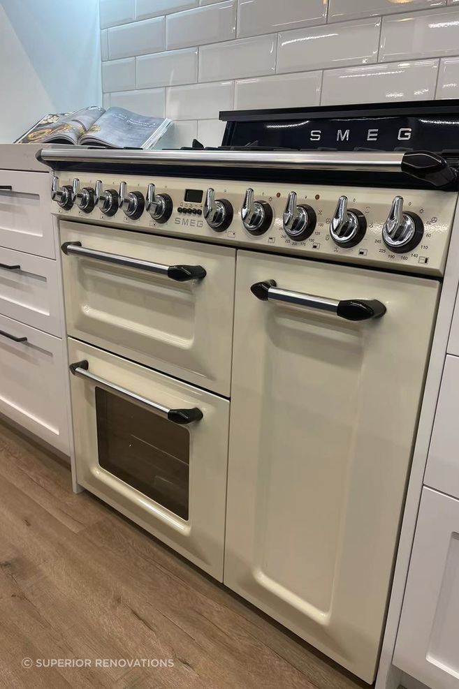 his cooking range has similar detailing in its front like the cabinet fronts and elevates this elegant classic kitchen design.