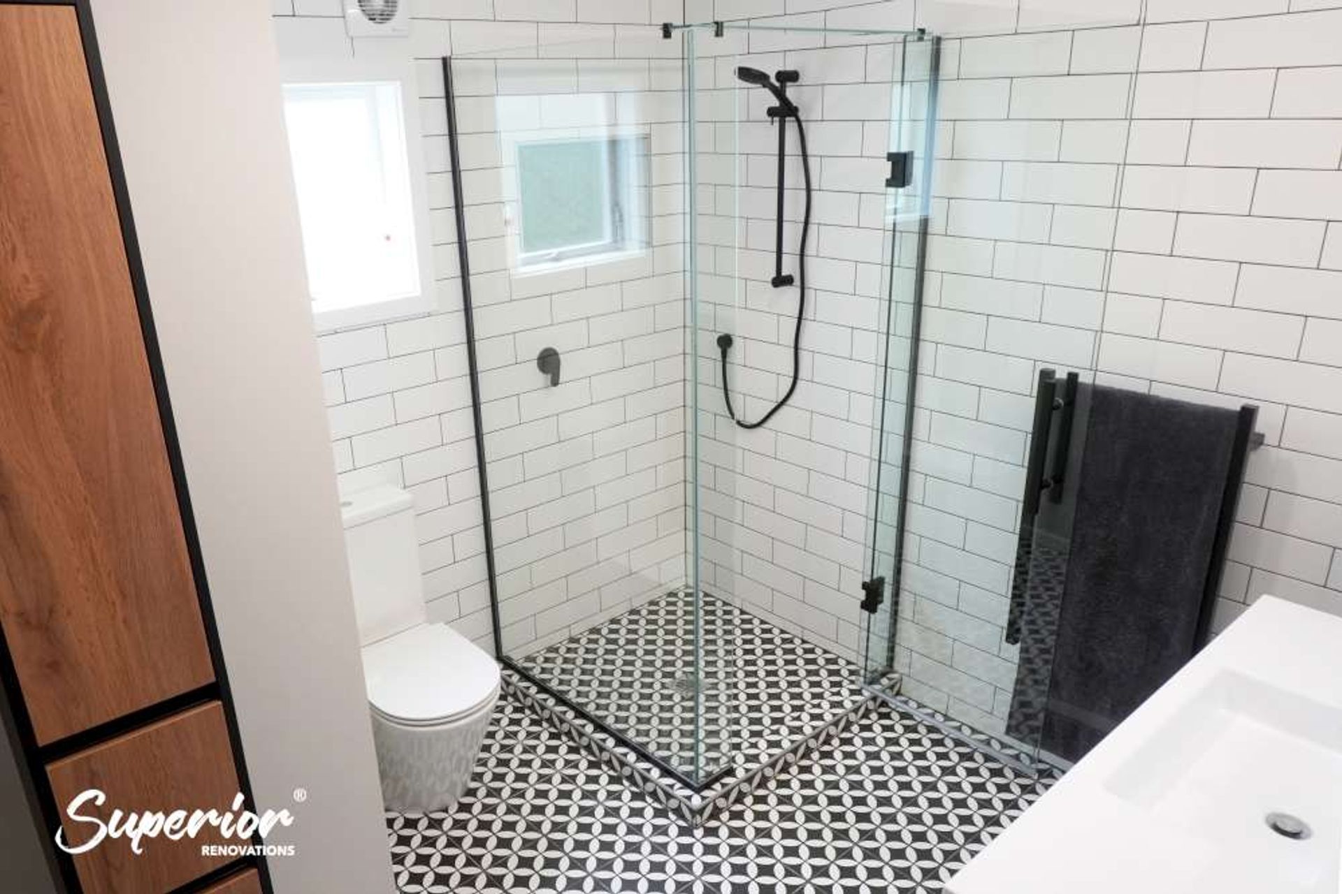 This is a great example of a shower in a small bathroom. The floor and wall tiles are carried forward into the shower to create continuity. This bathroom is a great example of how a well designed and planned bathroom can create an illusion of space.