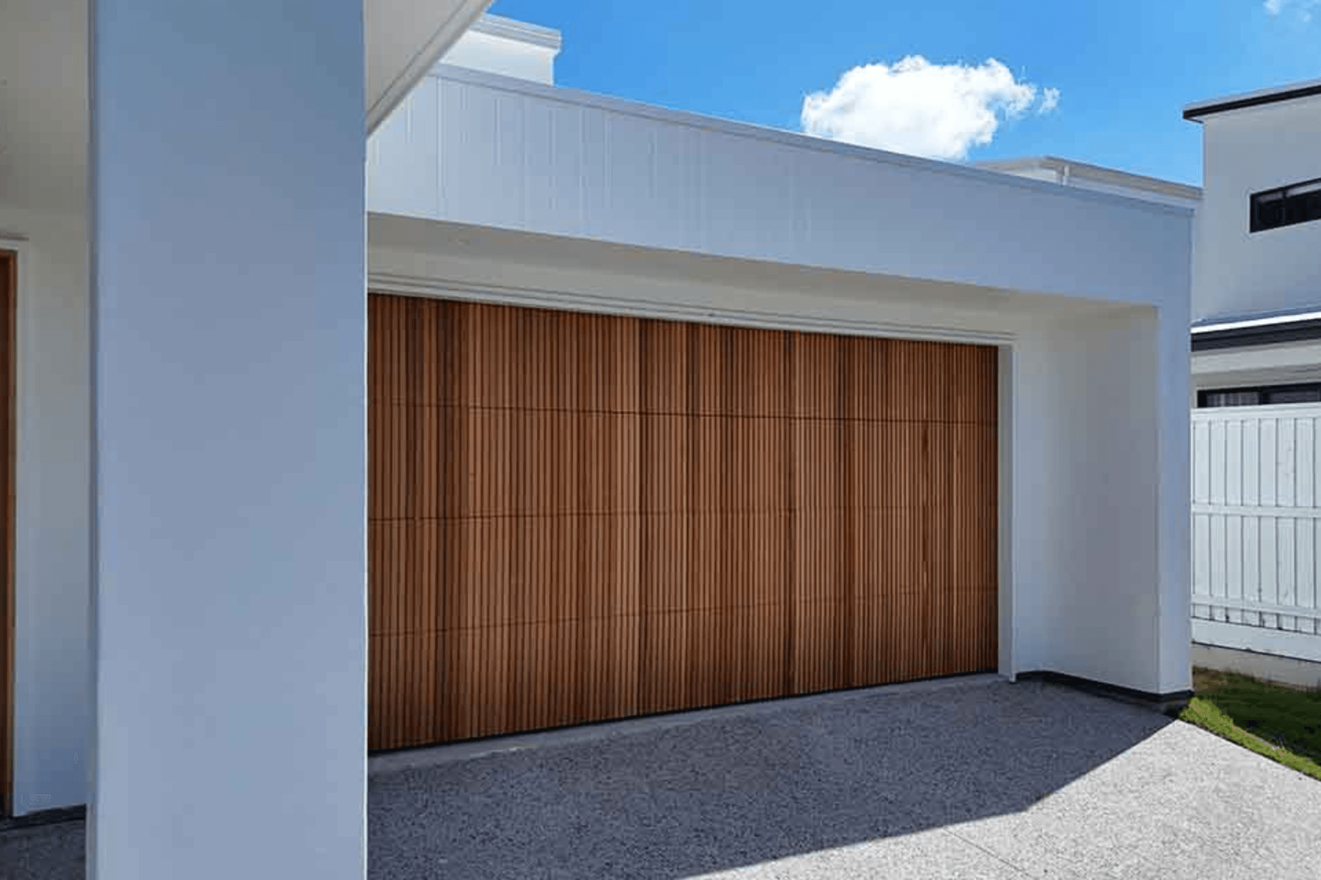 Real Timber Garage Door in Danmar Vertipanel design stained