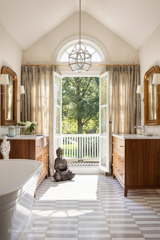 The primary bathroom incorporates a mix of timeless finishes, creating an warm ambiance of livable elegance.