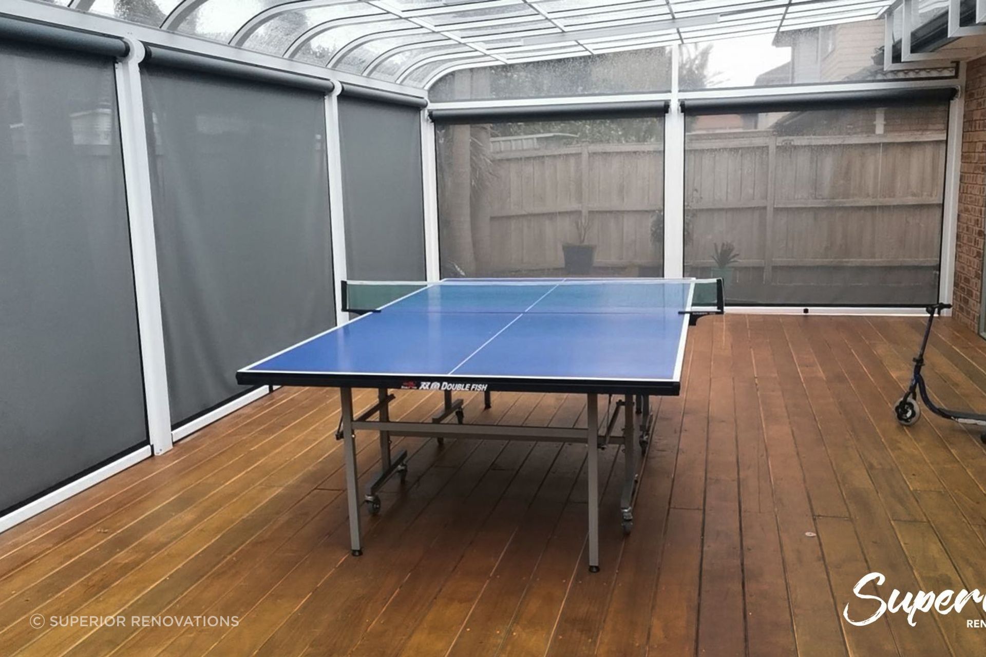 A great entertainment hub with a pool table inside the pergola with blinds