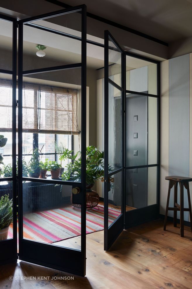 The steel-and-glass partition that leads to the couple’s suite was made by Alli Fabrication.