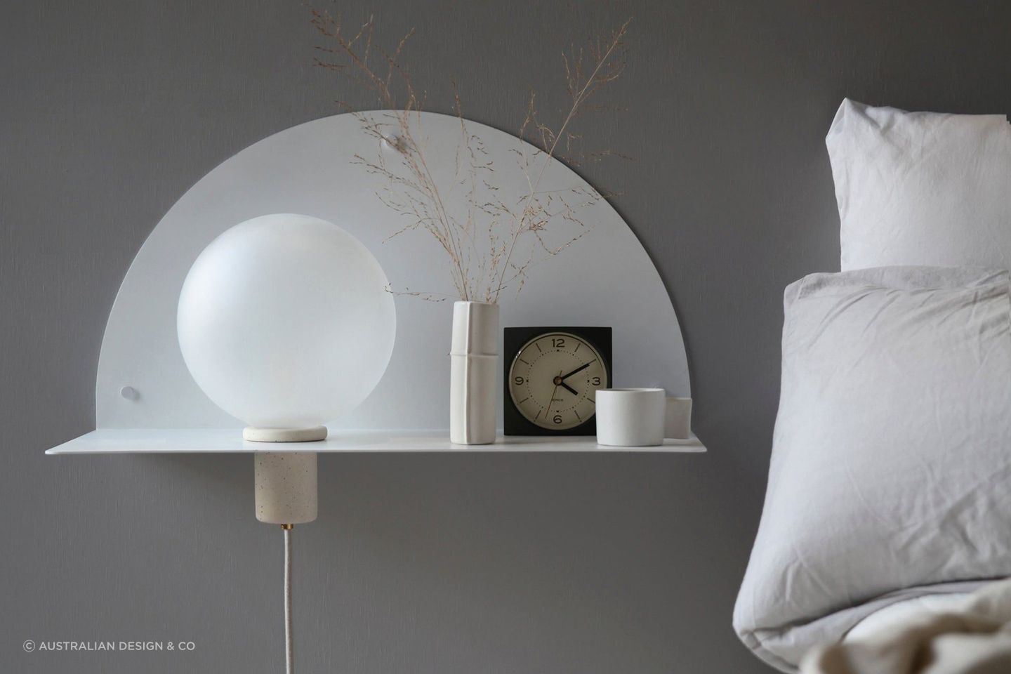 A wall-mounted bedside table maximises floor space, while complimenting a bedroom's interior design. Featured product: Lune Wall Shelf.