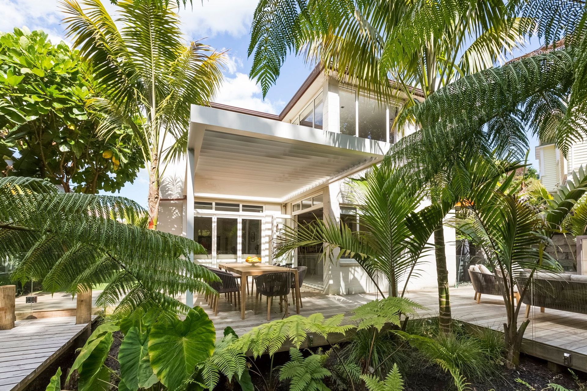 A fernery surrounded by a timber walkway is a great way to break up a back yard into a distinctive outdoor room, as well as being low maintenance and creating the effect of being situated within a lush forest.