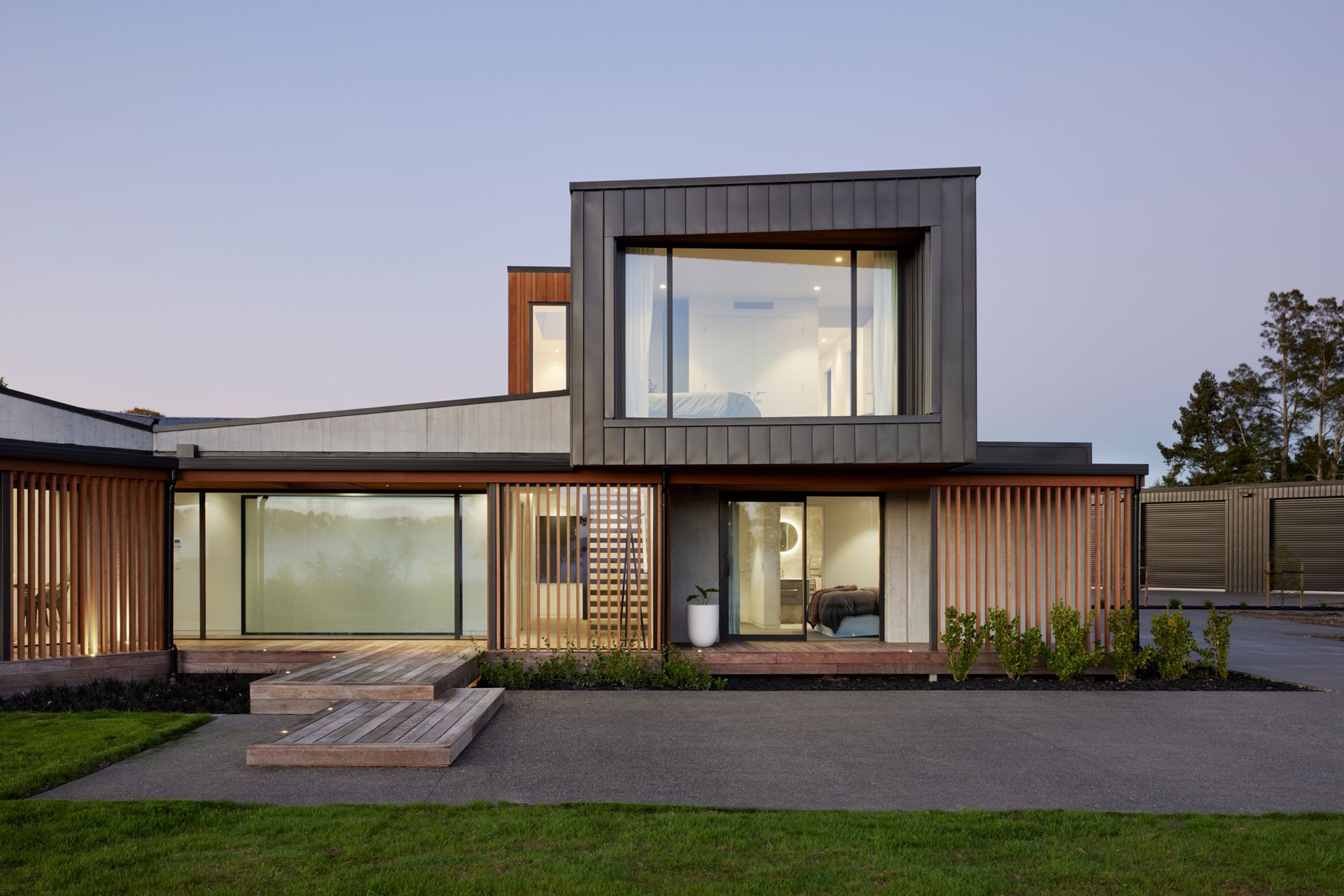 Clad in Eurostyle standing seam iron, the first floor cantilevers over the entrance and guest suite.