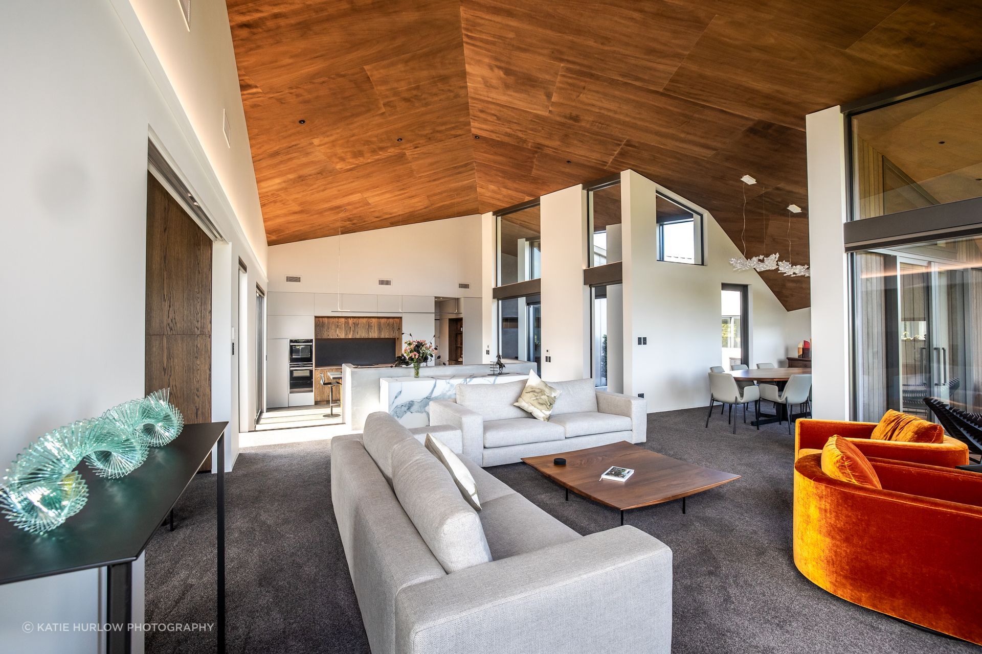 The shape of the interior is dictated by the form of the home, which opens up to the view and closes down towards the road frontage; the stunning timber ply lined ceiling accentuates the dynamic, sculptural form of the home.