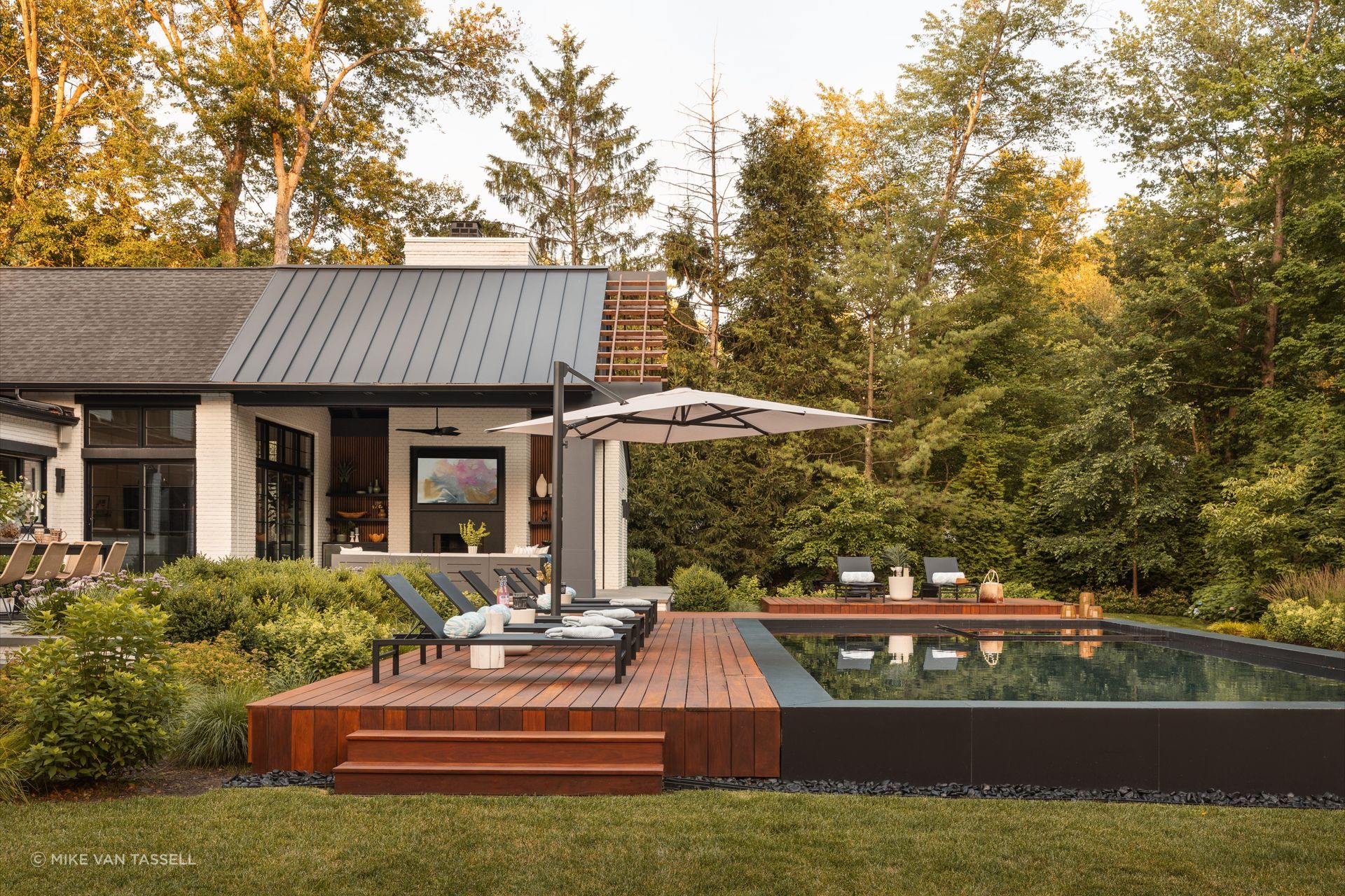 The sleek dark-plaster pool at Plan Architecture's project creates a calming backyard oasis.
