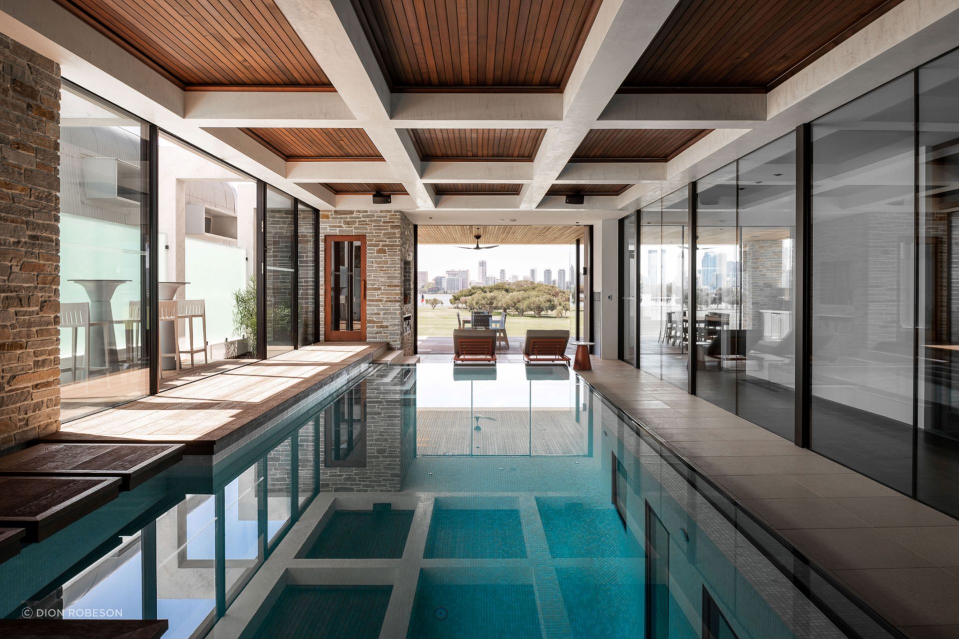 The indoor pool is accessed on the mid-level of the home, and has views directly out to the park and city beyond.