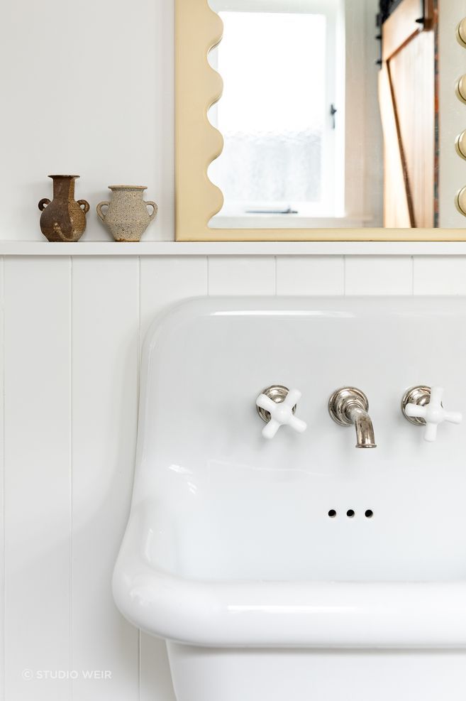 No attention to detail has been spared, with Perrin &amp; Rowe tapware also used in the downstairs bathroom and the curved mirror detailing a nod to the mirror in the children's bathroom.