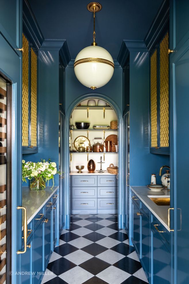 A corner of the house with a bold contrast of blue and brass details.