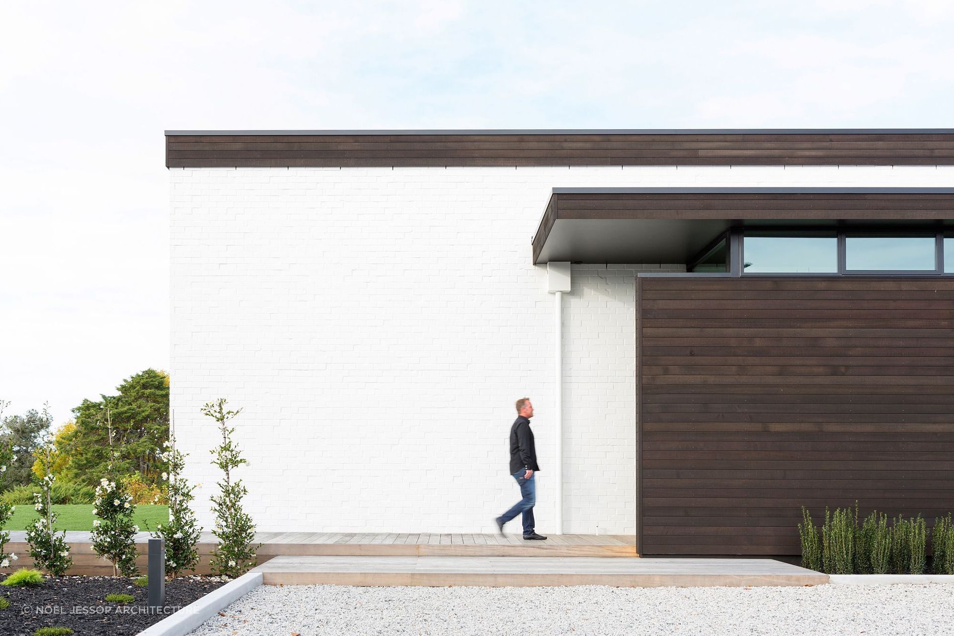 Black stained cedar against white brick cladding makes a fantastic pairing for the Black and White home on the banks of the Waikato River.