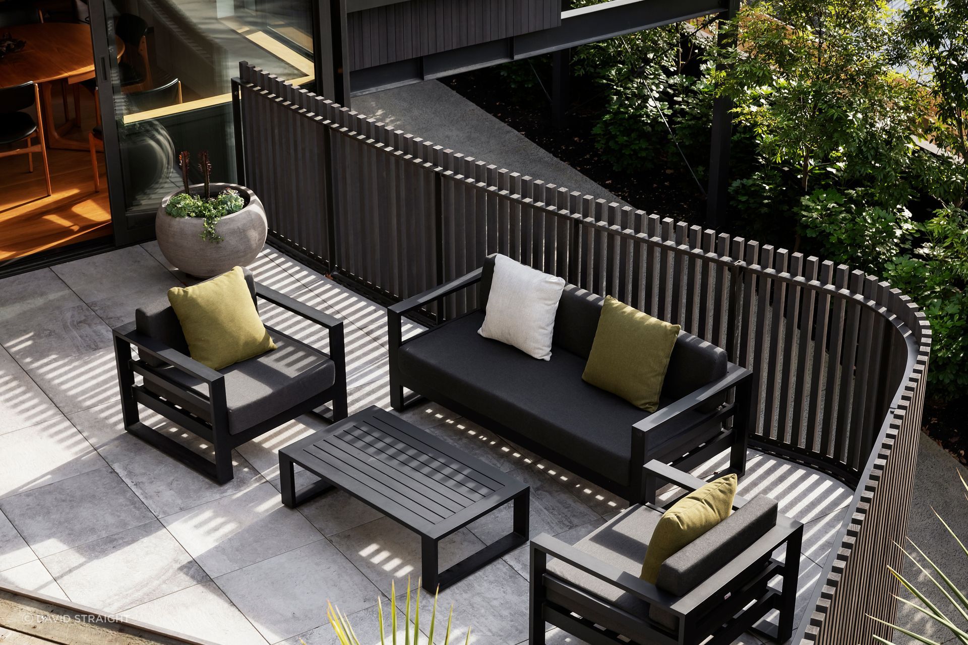 The morning terrace viewed from the elevated vegetable garden. The cladding and balustrades are eco-conscious Abodo wood. “You have a nice sense of containment when you're on the terrace, but with the ability to see through the gaps,” says Hamish.
