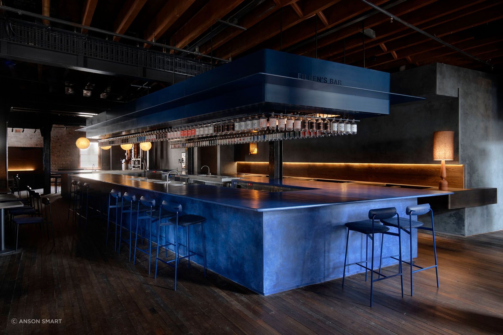 The bar is custom-made micro-cement in a vivid juniper berry blue.