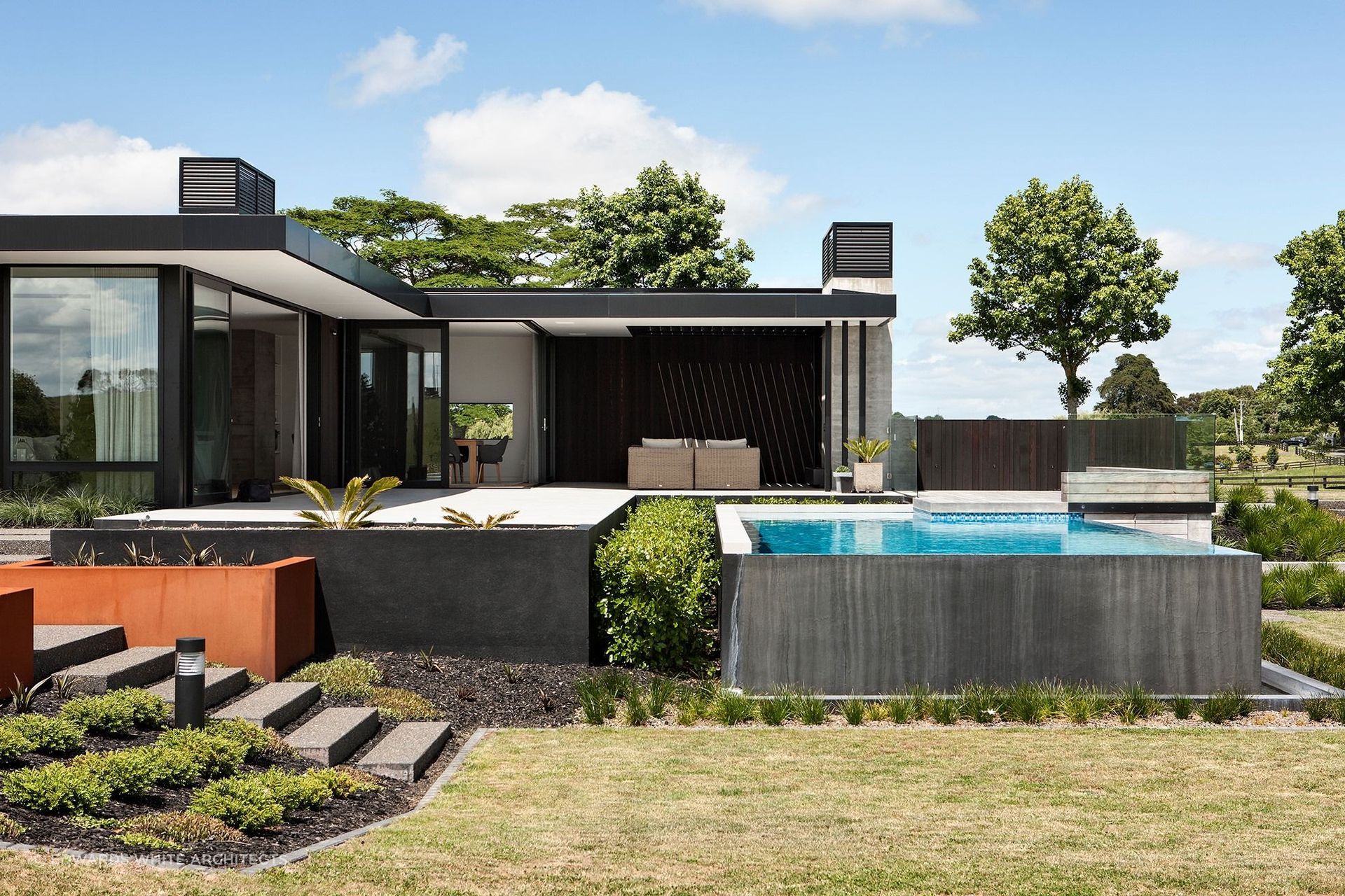 An outdoor living space featuring a lavish swimming pool.