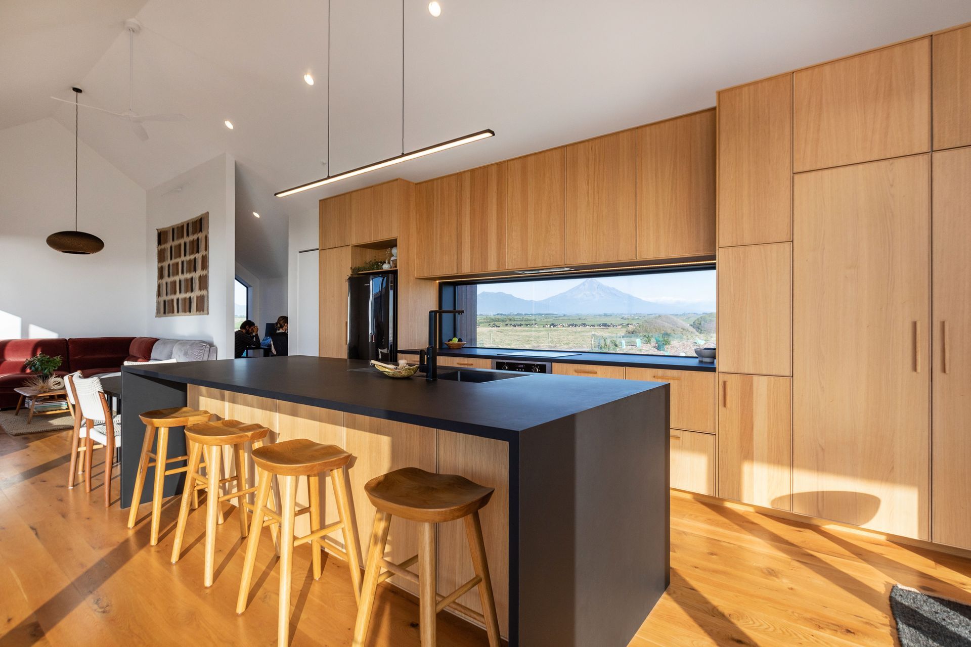 The main dwelling’s beautiful oak kitchen, with an expansive view of Mount Taranaki. | Photographer: Sandra Henderson