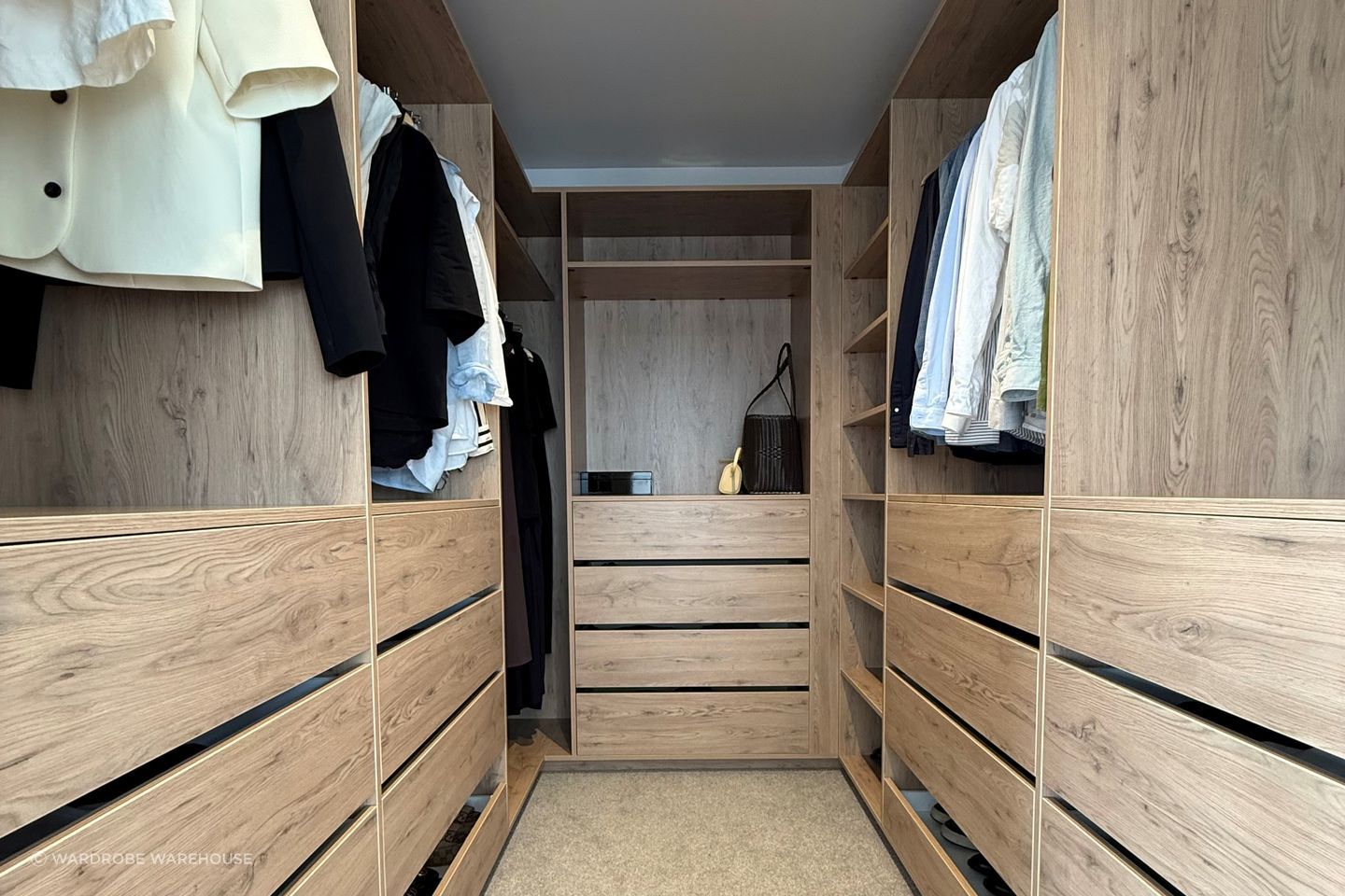 "We chose to upsize to 600mm-deep and 800mm-wide soft-close drawers, which increased the depth of the hanging space by 200mm. Because the width of hanging clothes is about 600mm, they fit perfectly. Even though the overall wardrobe depth extended by 200mm on both sides, there is still room for two people to be in there at the same time."