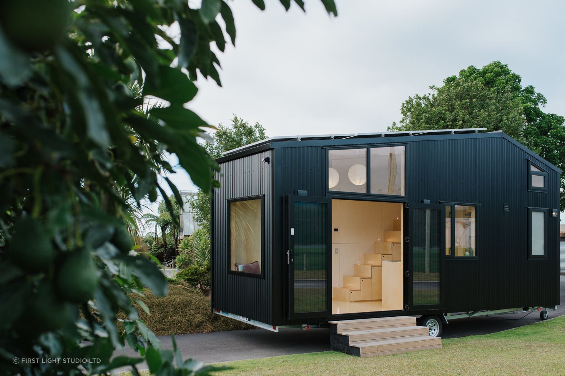A tiny home with wheels presents both design challenges and opportunities, wonderfully demonstrated in this solar-powered tiny house in Ohariu by First Light Studio - Photography: Build Tiny