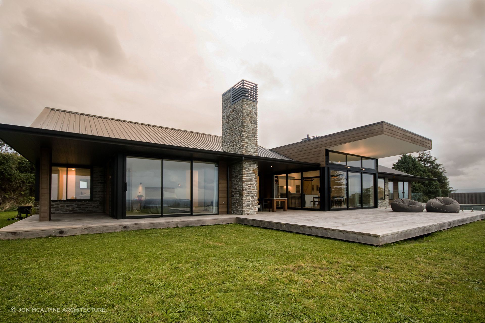 Natural materials like stone and cedar are elegantly used at Ohauiti House.