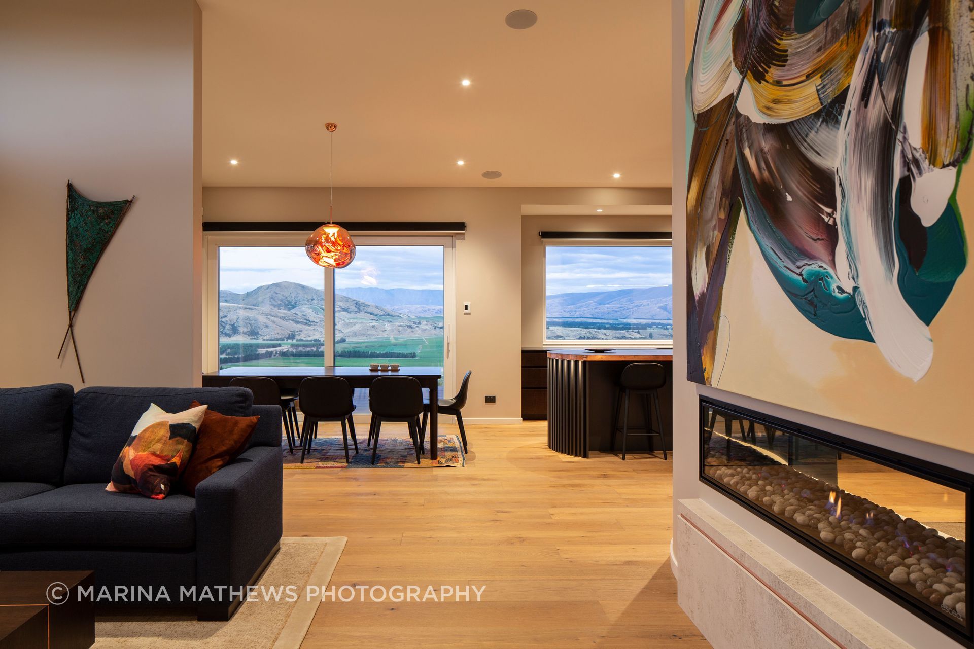 On one side of the gas fireplace the lounge offers a cosy retreat.