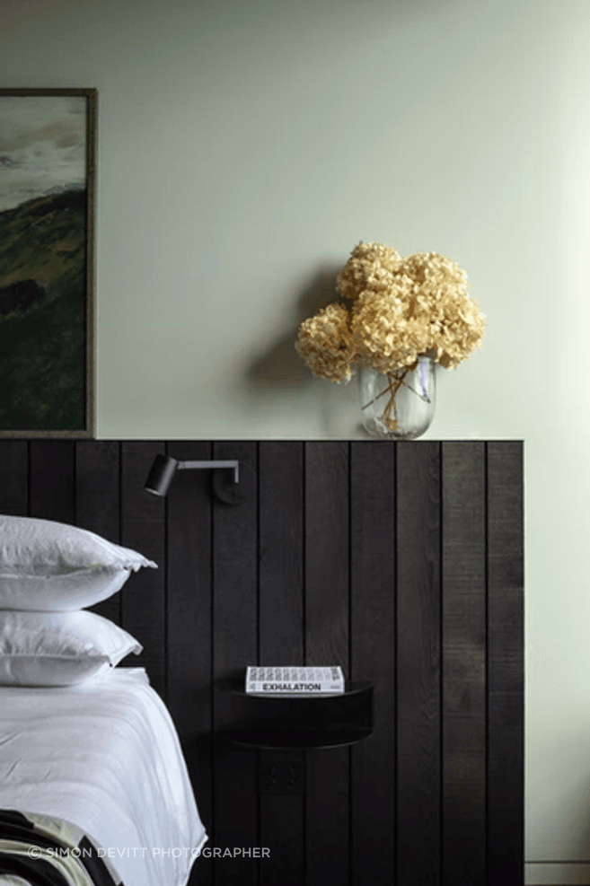 One of two master bedrooms that are both oriented to the views. The side table is from Made of Tomorrow.