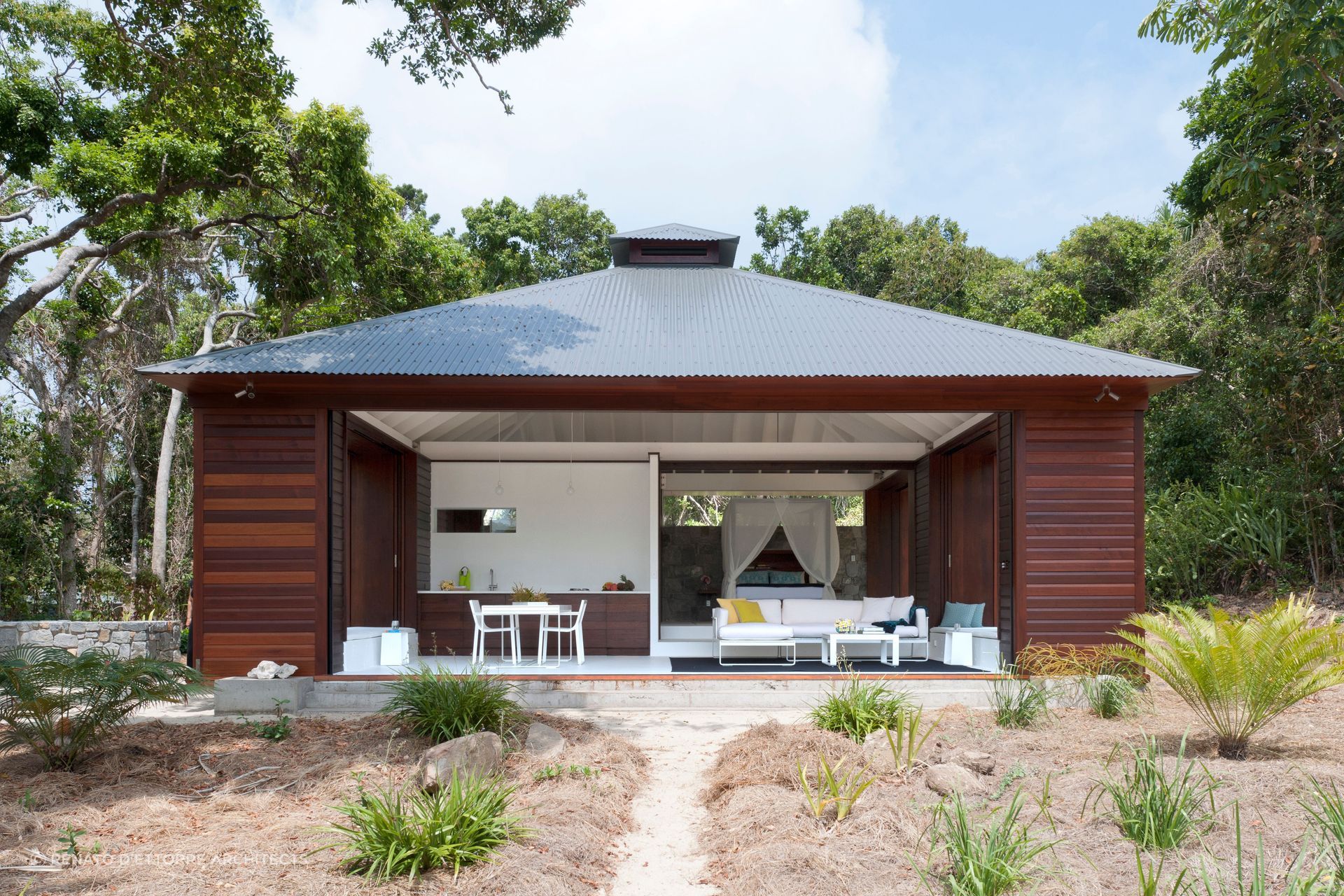 The exterior of this Tropical Beach House is designed to provide protection from the elements. Photographer: Willem Rethmeier