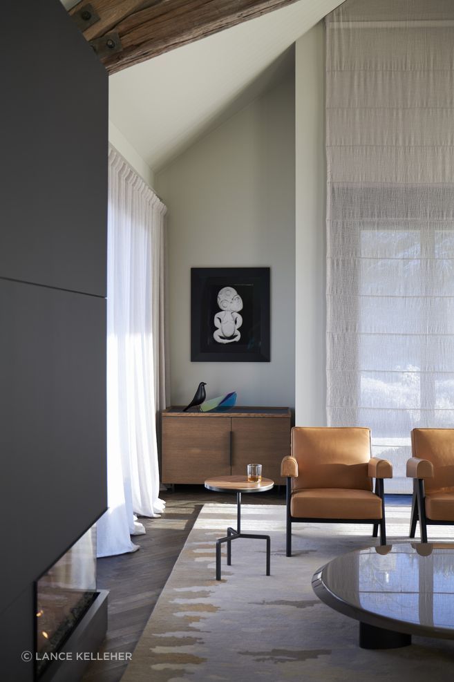 The new fireplace on the left; soft linen drapes soften the light coming in; and a rug called 'Pike' that is a part of a collection Anna-Carin designed herself, which references a fish her dad used to catch in the lake where she spent her childhood.