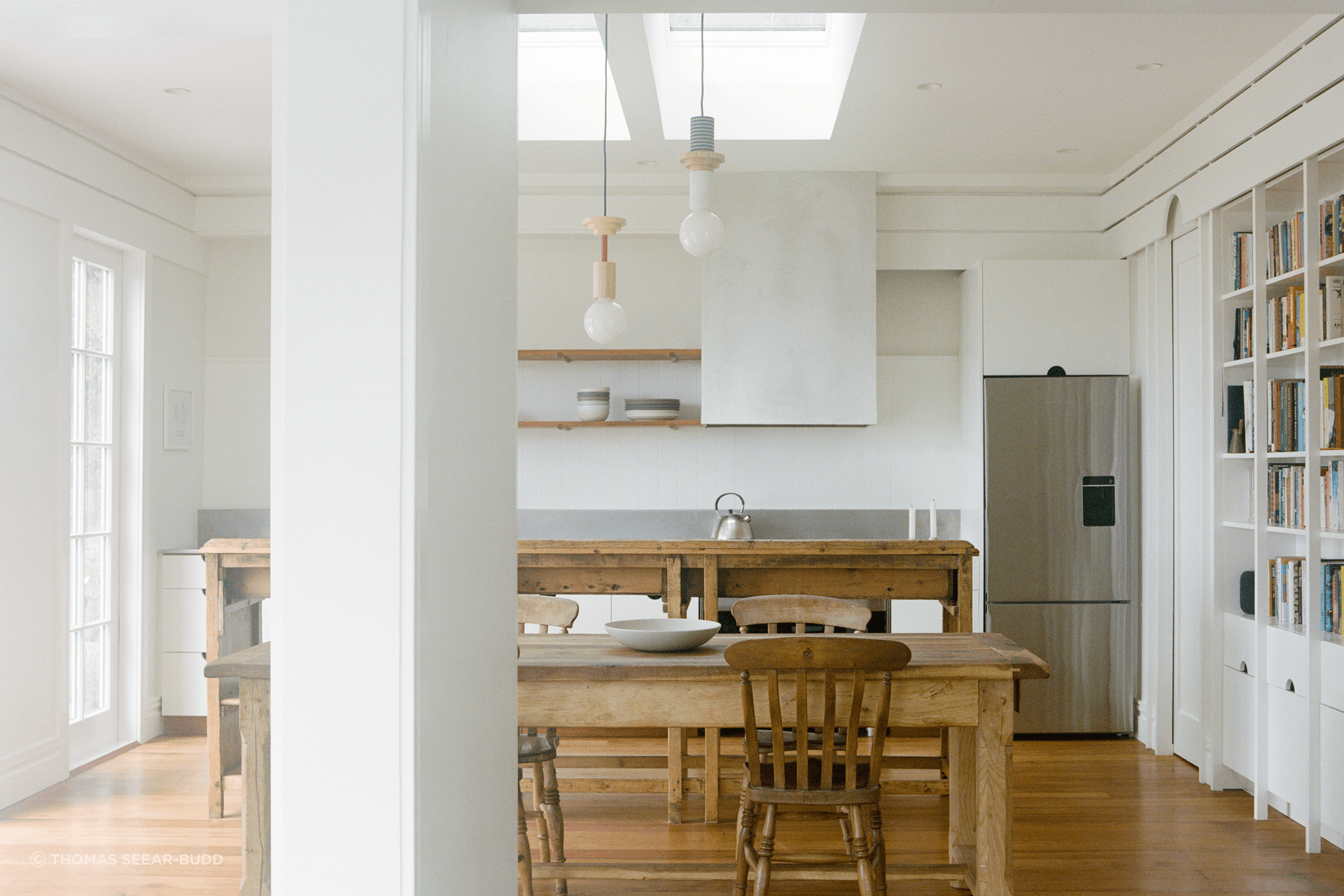The new kitchen is flooded with lights and connects with the harbour views.