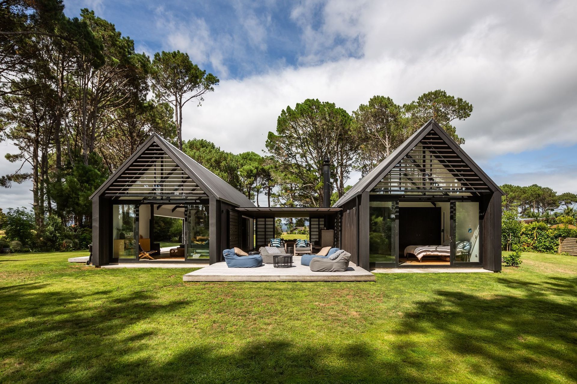 The two gabled forms are connected by a central linking building that houses a sheltered courtyard.