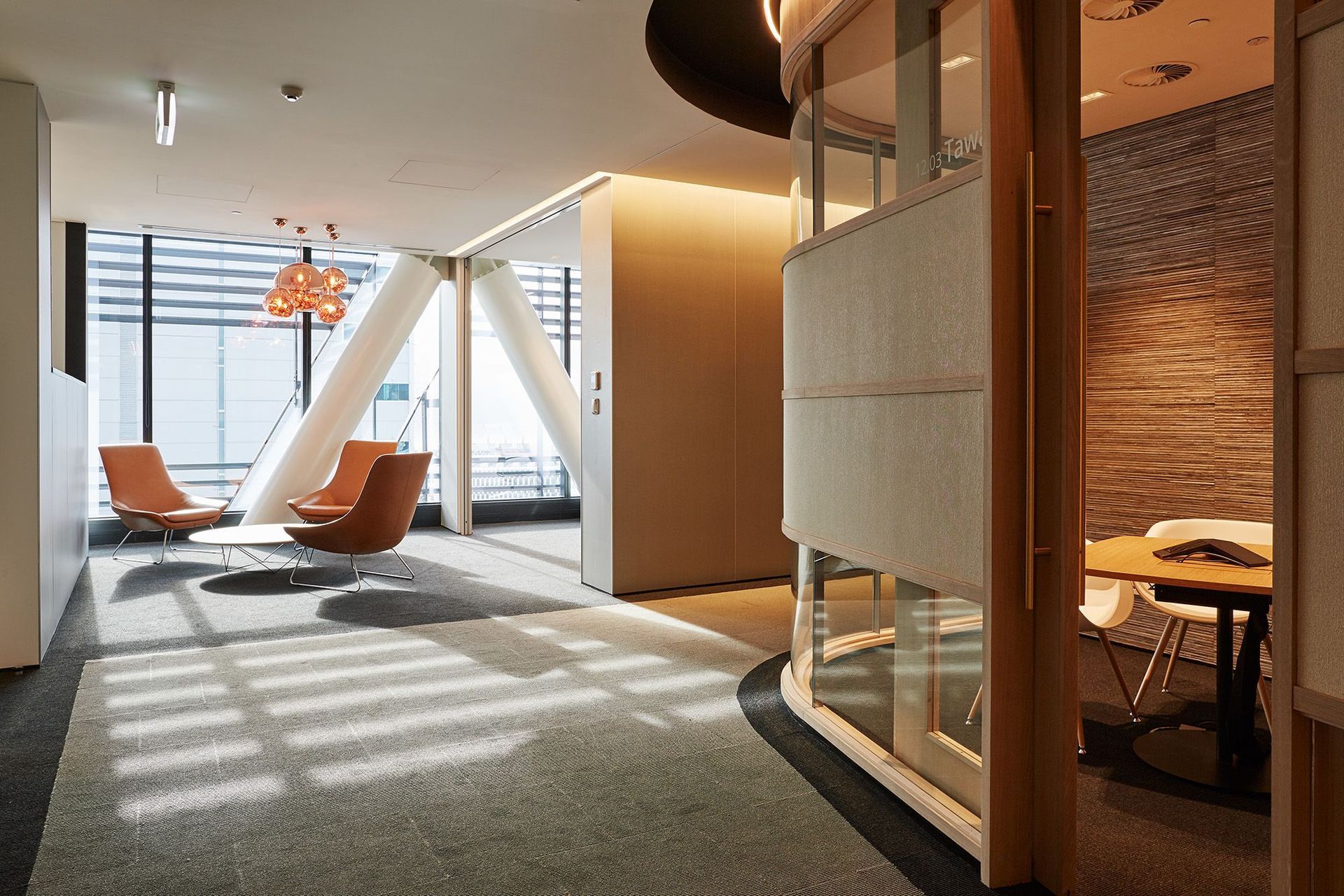 Intimate, light-filled nooks and crannies offer a sense of home in Deloitte's 12th floor office, seen above and above top.