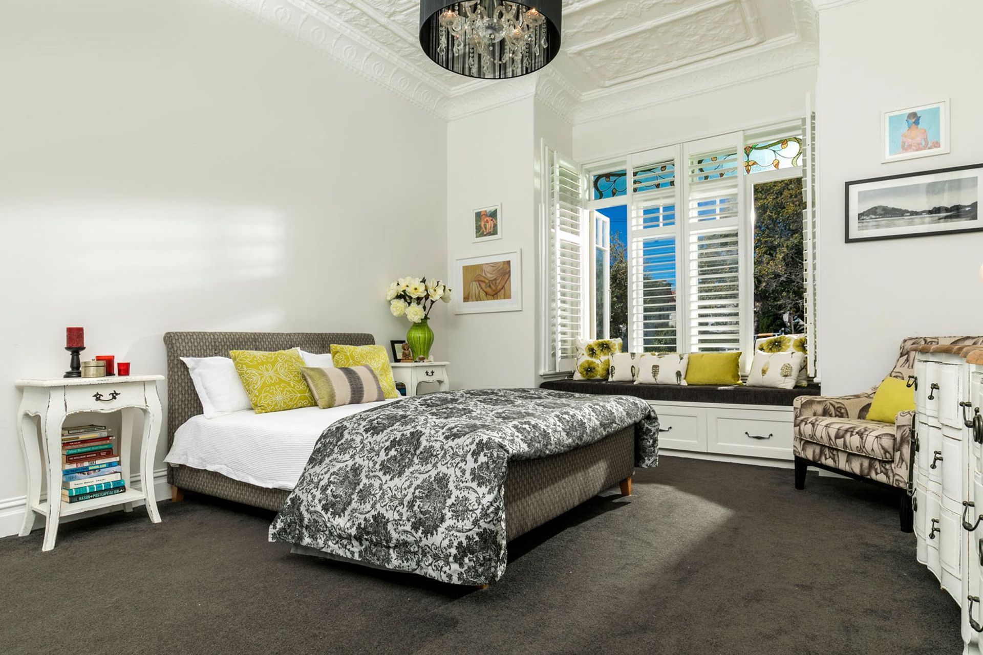 A contemporay chandelier added a touch of lux to the metal ceiling, and a collection of pattern and texture in the fabrics, created interest a touch of eclectic luxury.