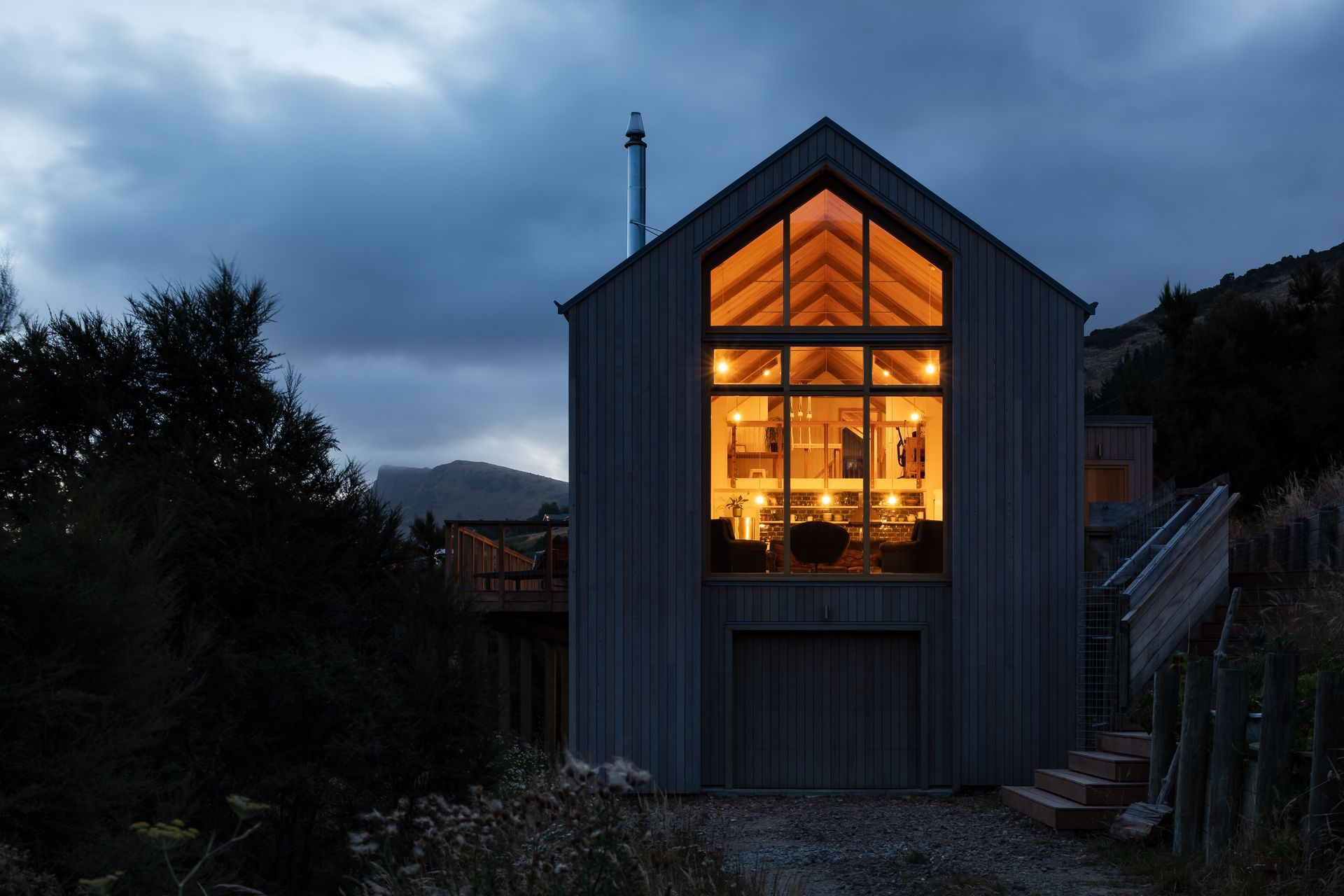 The lofty interior is enhanced by warm wood and glass, imbuing the spaces with a golden glow.