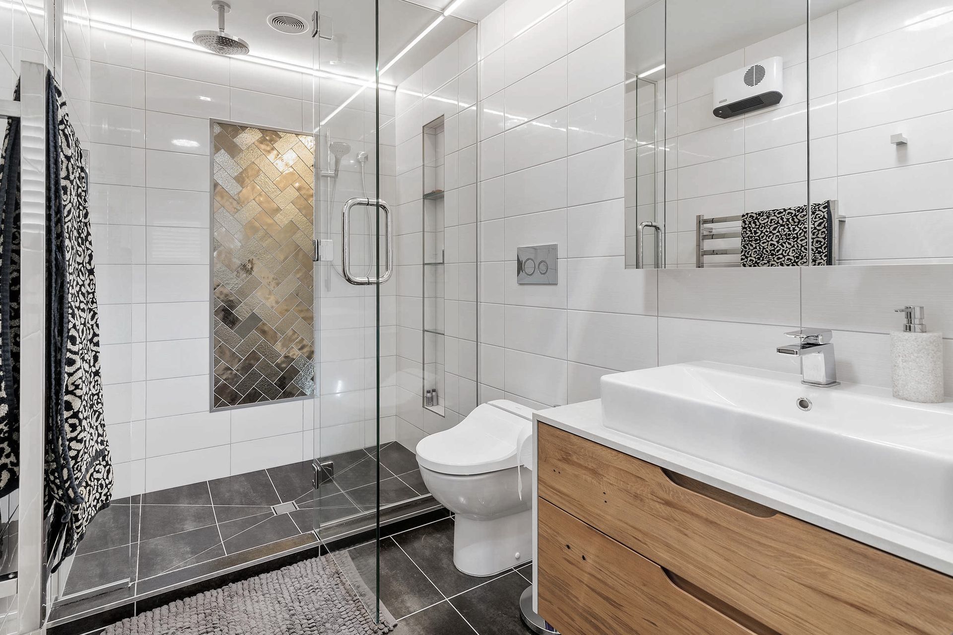 Ensuite bathroom with double shower, custom vanity, mirror storage and bidet. This gorgeous vanity with caesarstone top and solid timber drawers in addition to the mirror cabinet offers great storage solutions 
