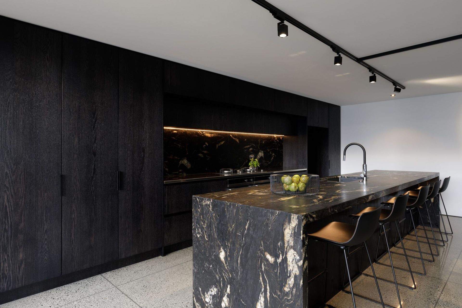 The large island bench is a popular part of this family home, not just for cooking but also for working, homework and socialising.