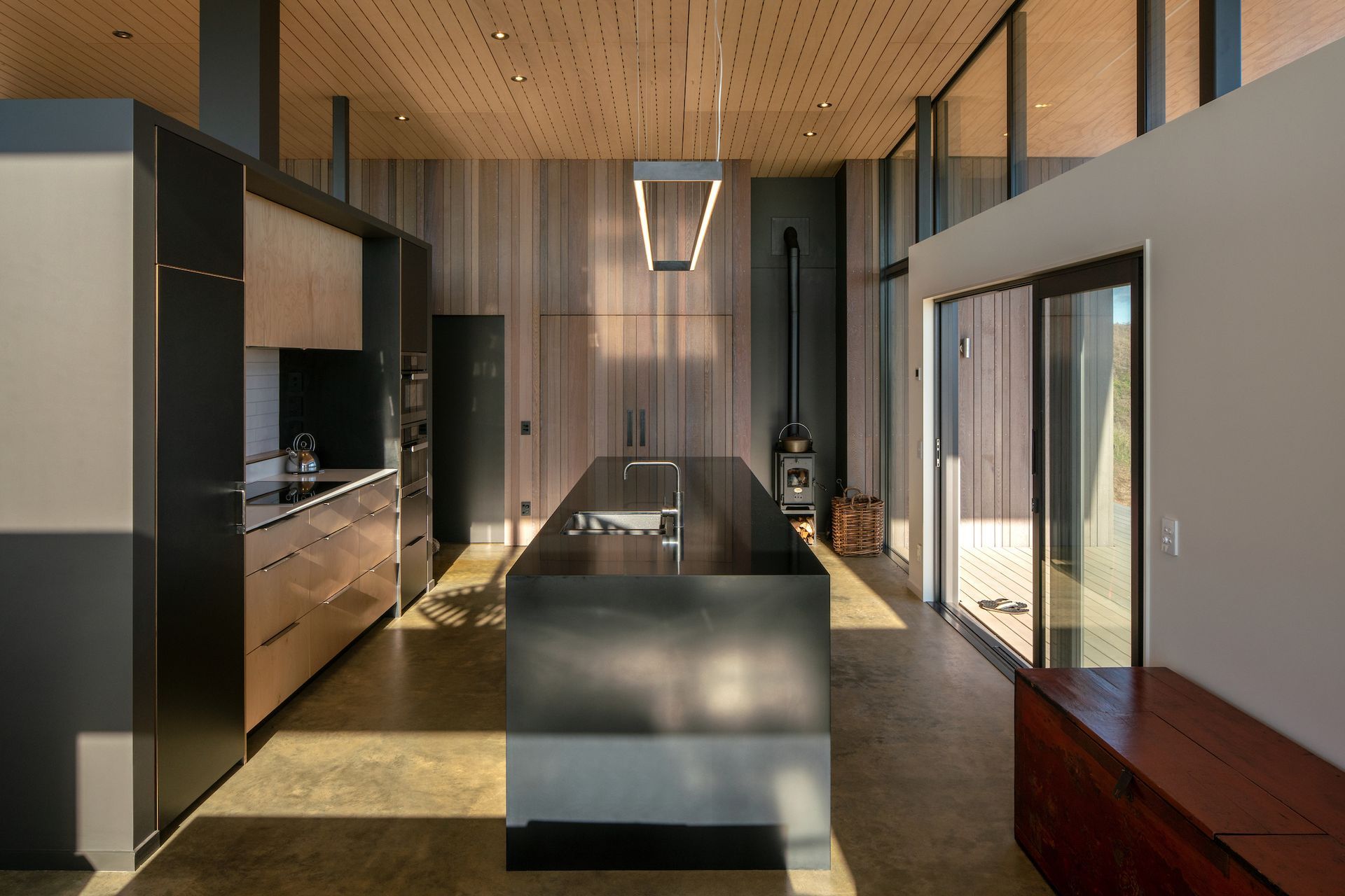 The free-standing kitchen unit does double-duty providing necessary storage for appliances and accessories, while also being an office niche on the reverse side.