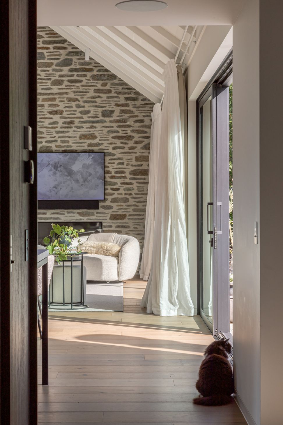 Schist stone ant timber plank flooring add warmth and texture to the interior