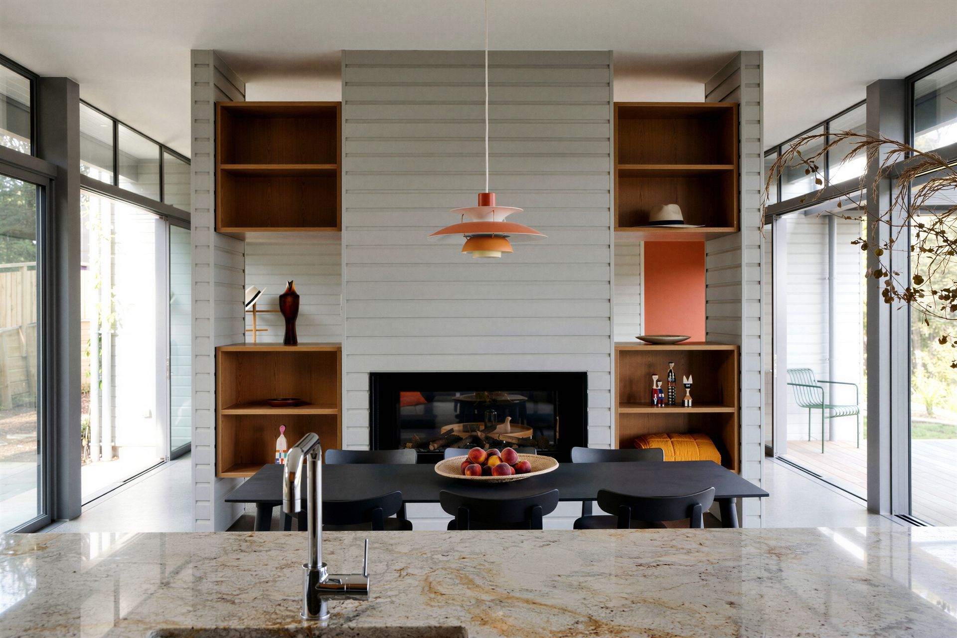 The open-plan kitchen flows naturally into the dining and living areas, creating a generous social space designed for family life. Warm oak cabinetry, natural materials and abundant daylight reinforce the home's relaxed coastal character.