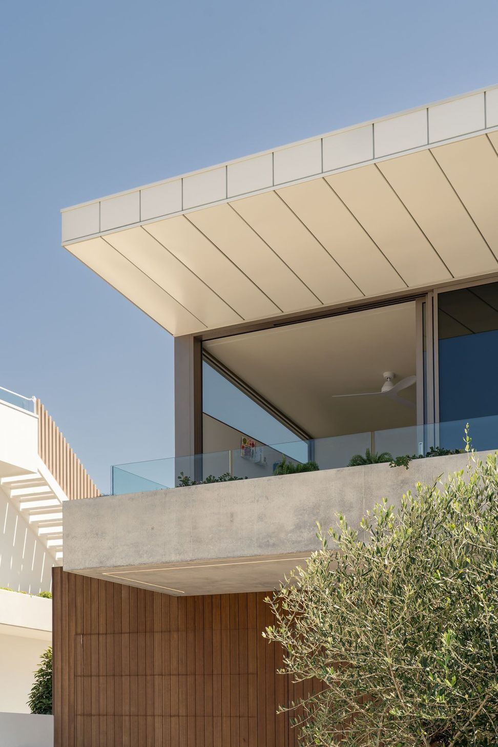 House on Pacific - Exterior. Cantilevered roof edge and glazed upper level against the sky.