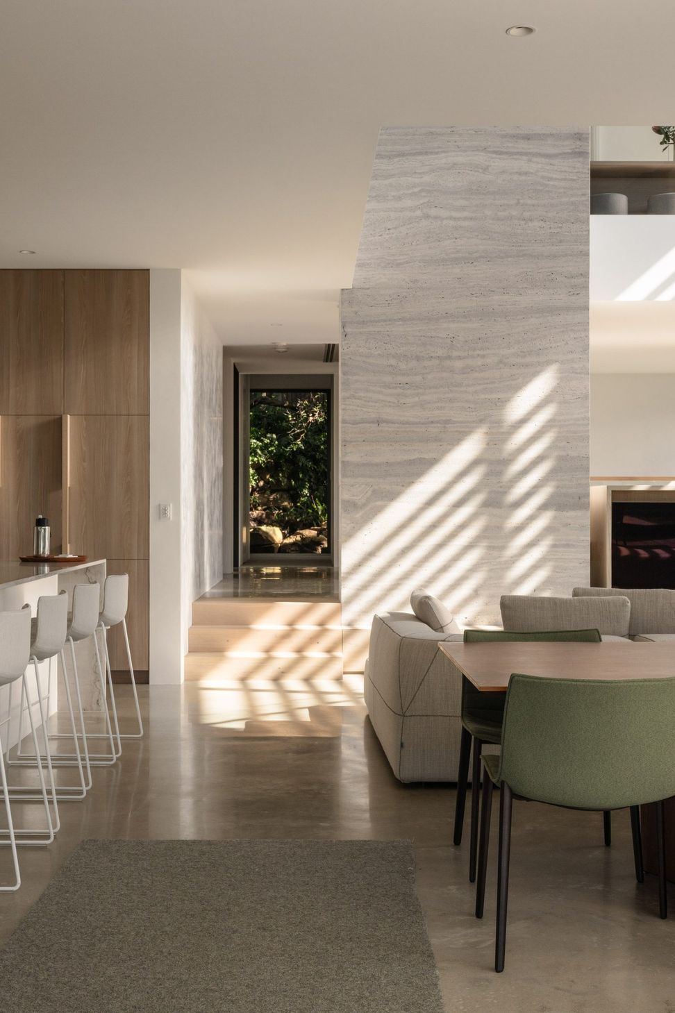 Decade House - Dining Room. Dining area beside the kitchen island, looking toward the fireplace.