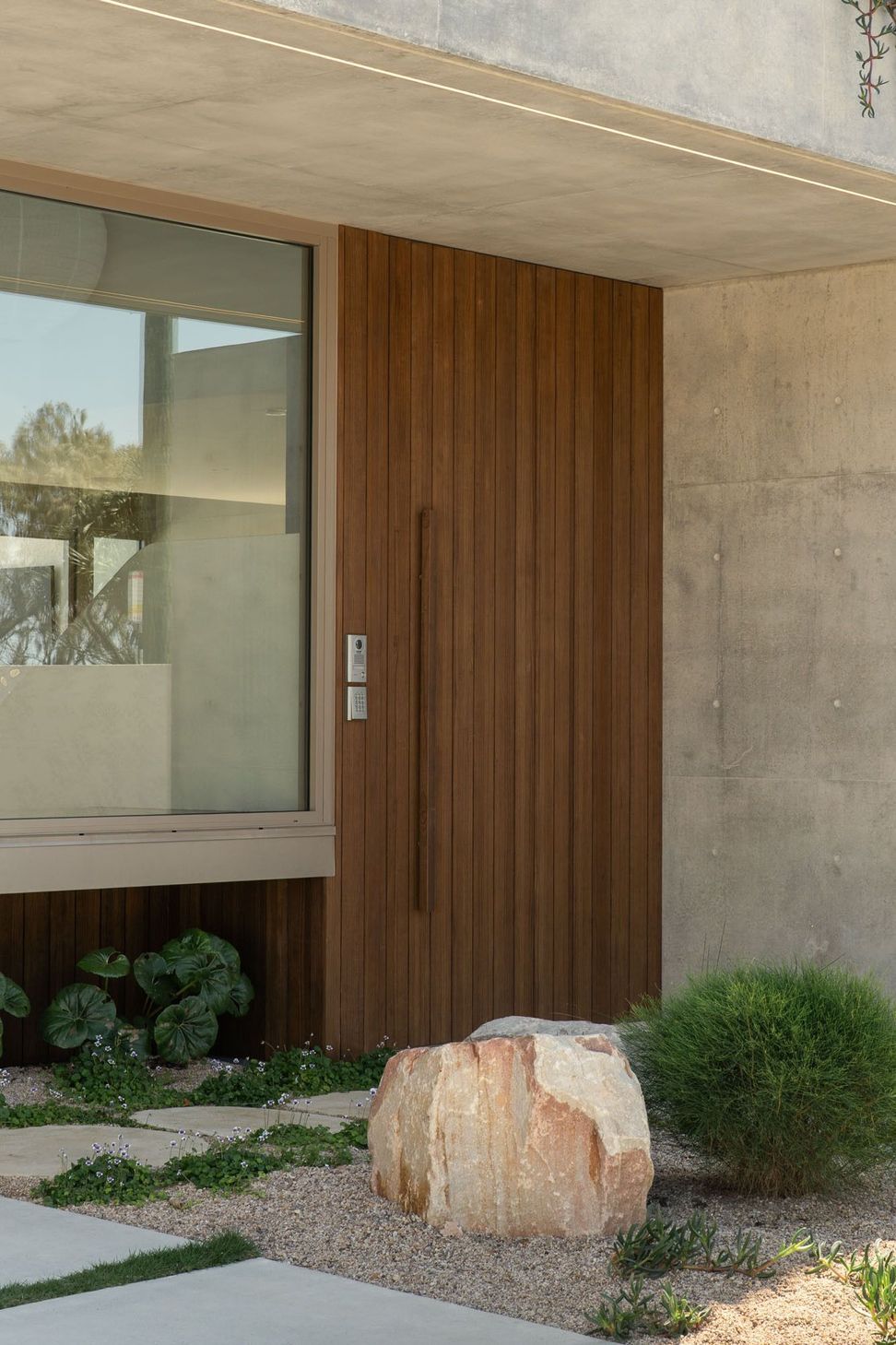 House on Pacific - Entry. Timber clad entry beside an off-form concrete wall.